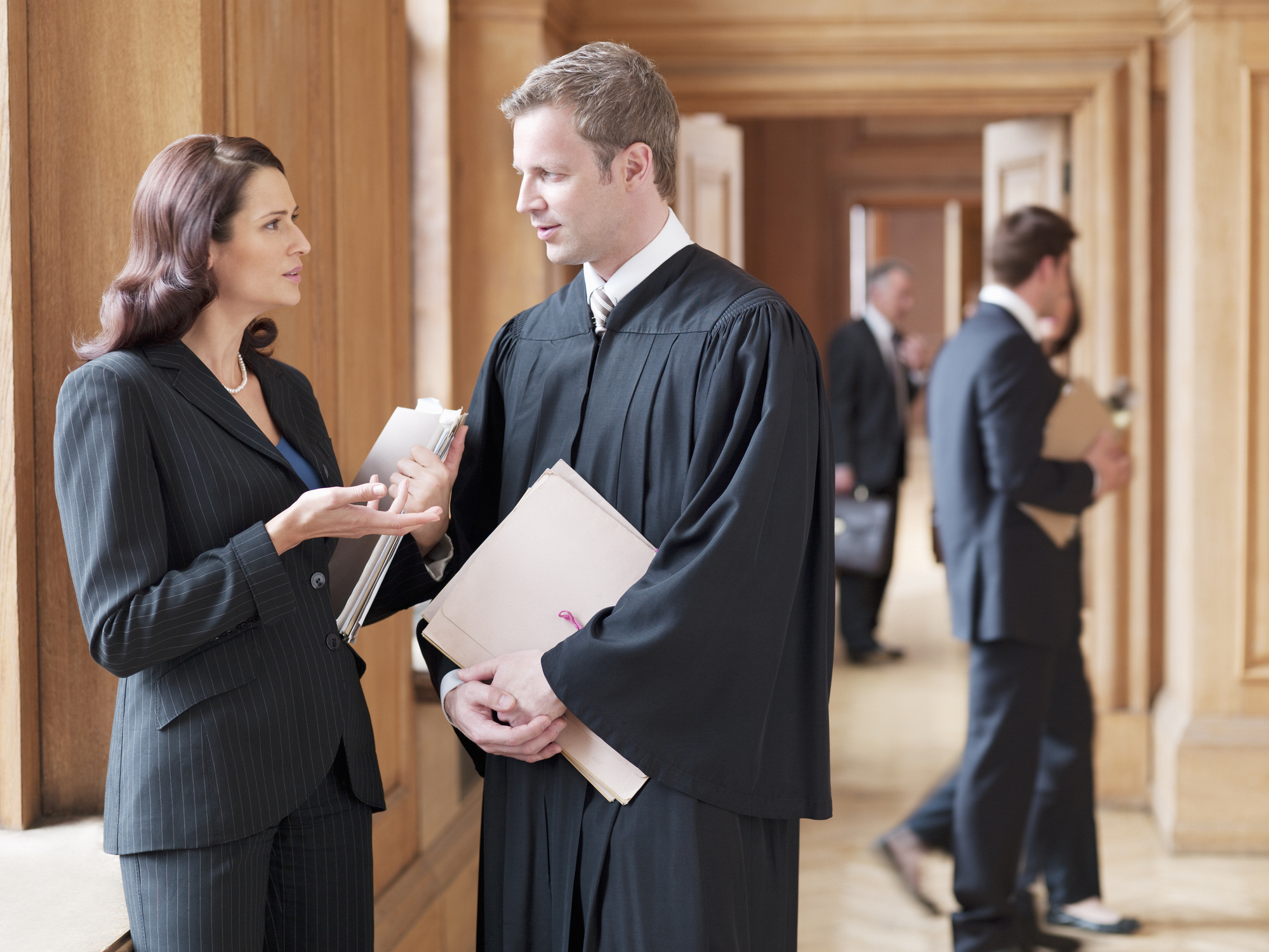 Lawyer and judge discussing in hallway