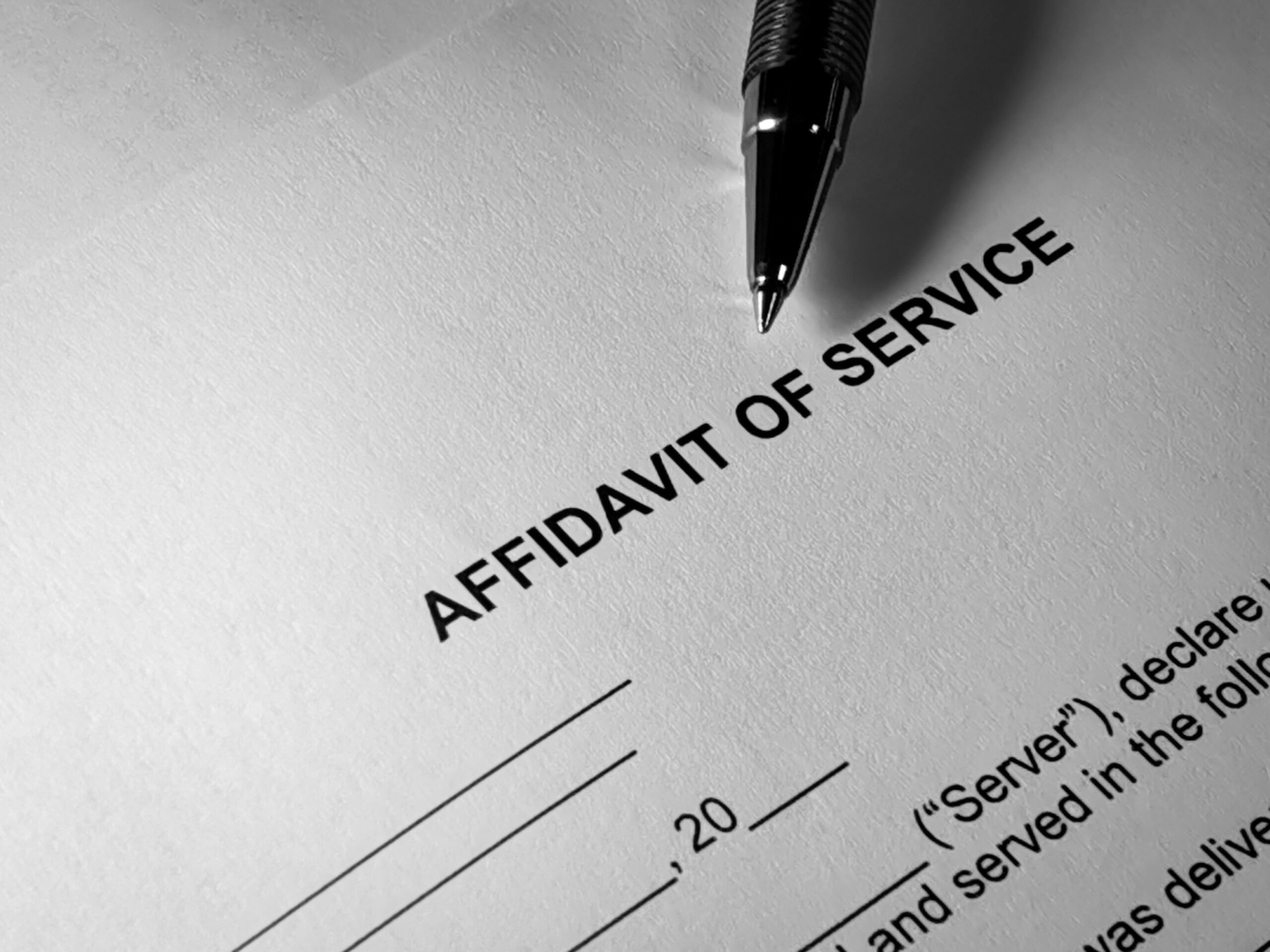 Pen resting on Affidavit of Service form