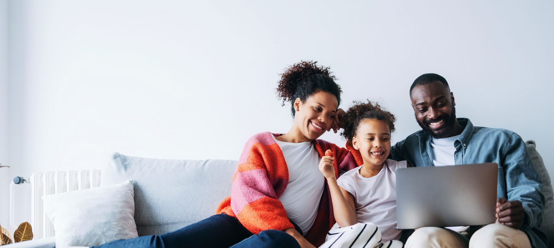 Parents and child smiling at screen